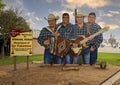 Wooden art piece featuring Los Palominos along US 90 Highway passing through Uvalde, Texas