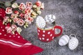 Easter composition with white and black polka dot eggs in a red and white polka dot cup, eustoma flowers, red shawl Royalty Free Stock Photo