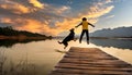 child and dog jumping into the lake with dramatic tone Royalty Free Stock Photo