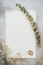 Rustic background with floral elements and golden rings. White blank wedding invitation mockup Royalty Free Stock Photo