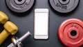 A smartphone with white screen and weightlifting on metal background Royalty Free Stock Photo