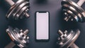 A smartphone with white screen and weightlifting on metal background Royalty Free Stock Photo