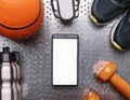A smartphone with white screen and sneekers on metal background Royalty Free Stock Photo