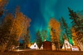 Northern lights dancing over the light up Tipi or Tepees at Aurora Village in Yellowknife, Northwest Territories, Canada. Royalty Free Stock Photo