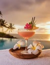 Tropical cocktail on the beach with palm trees at sunset. Royalty Free Stock Photo