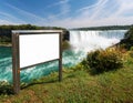 Blank white sign with metal frame in front of water falls and blue sky Royalty Free Stock Photo