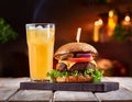 Tasty grilled cheeseburger served with lemonade and mustard. Barbecue hamburger with vegetable Royalty Free Stock Photo