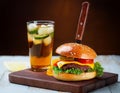 Tasty grilled cheeseburger served with lemonade and mustard. Barbecue hamburger with vegetable Royalty Free Stock Photo