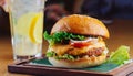 Tasty grilled cheeseburger served with lemonade and mustard. Barbecue hamburger with vegetable Royalty Free Stock Photo