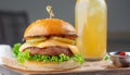 Tasty grilled cheeseburger served with lemonade and mustard. Barbecue hamburger with vegetable Royalty Free Stock Photo