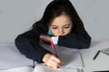 Teenage girl makes concentrated her school homework Royalty Free Stock Photo
