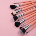 Makeup Brush Set with Peach Handles on Pink Background Royalty Free Stock Photo