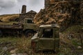 Abandoned vintage trucks in a grassy hillside under a cloudy sky at an old settlement at Ushguli, Georgia Royalty Free Stock Photo