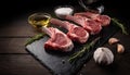Raw lamb chops. Rack of Lamb with garlic, rosemary and spices on black slate tray Royalty Free Stock Photo
