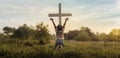 Praising the lord concept. Back view of a young girl with her arms raised to the sky in thankfulness and prayer Royalty Free Stock Photo
