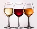 Three wine glasses over white background. White wine, rose, and red. Royalty Free Stock Photo