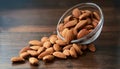 Almonds Almond Nuts Food. Raw almonds pouring out of a glass bowl onto a wood surface. Royalty Free Stock Photo
