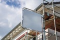 House with scaffolding with blue sky background with big sign Royalty Free Stock Photo
