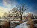 Picturesque view of a lone tree near a small village in a wintry landscape. AI Generated Image. Royalty Free Stock Photo