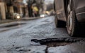 Close up of a car tire by a pot hole. Generative AI Royalty Free Stock Photo