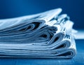 Stack of financial newspapers in monochrome blue Royalty Free Stock Photo