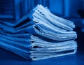 Stack of financial newspapers in monochrome blue Royalty Free Stock Photo