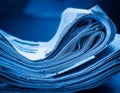 Stack of financial newspapers in monochrome blue Royalty Free Stock Photo