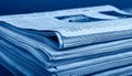 Stack of financial newspapers in monochrome blue Royalty Free Stock Photo