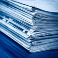 Stack of financial newspapers in monochrome blue Royalty Free Stock Photo