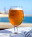 Beer glass on a blurred background of the sea and beach. Royalty Free Stock Photo