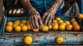 Open air market. Elderly hands arranging vibrant oranges on a rustic wooden cart. Royalty Free Stock Photo