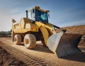 Yellow excavator on a construction site against blue sky Royalty Free Stock Photo