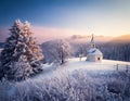 Scenic view of a chapel in a wintry mountainous landscape. AI Generated image. Royalty Free Stock Photo