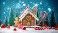 Gingerbread house in christmas landscape surrounded by candy canes and sweets Royalty Free Stock Photo