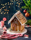 Gingerbread house in christmas landscape surrounded by candy canes and sweets Royalty Free Stock Photo