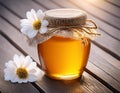 Honey in a glass jar with white flowers on floor board Royalty Free Stock Photo