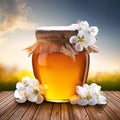 Honey in a glass jar with white flowers on floor board Royalty Free Stock Photo
