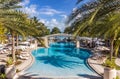 Resort pool with palms and sun beds Royalty Free Stock Photo