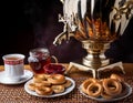 Traditional Russian tea from Samovar with cakes, bagels and raspberry jam Royalty Free Stock Photo