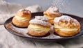 Powdered Cream Puffs. Cream puffs filled with pastry cream and sprinkled with powdered sugar. Royalty Free Stock Photo