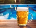 Beer-shot. A beer at the pool. Royalty Free Stock Photo