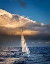 Sailing yacht in the sea at sunset. Dramatic cloudscape. Royalty Free Stock Photo