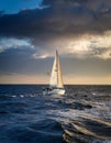 Sailing yacht in the sea at sunset. Dramatic cloudscape. Royalty Free Stock Photo
