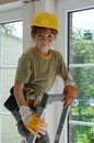 Little workman with security helmet on a ladder Royalty Free Stock Photo