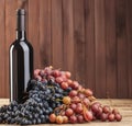 wine bottle and berries on a table - Generated with Ai. Royalty Free Stock Photo