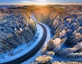 Road serpentine in wintertime from above. Asphalt road serpentine in snowy wintertime. Cold Royalty Free Stock Photo