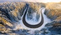 Road serpentine in wintertime from above. Asphalt road serpentine in snowy wintertime. Cold Royalty Free Stock Photo