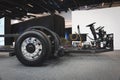 Image of an electric vehicle chassis on display at an event, with components such as wheels, steering Royalty Free Stock Photo