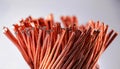 coiled copper wire resting on a reflective white surface Royalty Free Stock Photo