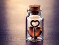 Love key inside miniature glass bottle. Love potion with key Royalty Free Stock Photo